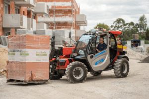 Manitou MT625e electric telehandler moving bricks